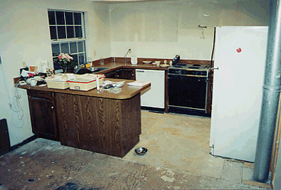 This is the closest thing I have to a before picture. The upper cabinets have been removed, in addition to the ugly linoleum and worn carpeting. We discovered the furnace vent at the right when we removed the pantry cabinet. I always wondered why that cabinet was only half as deep as it could have been.