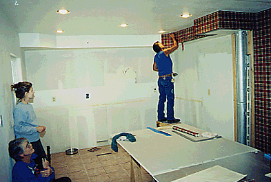 James and the women worked on wallpaper all day as I bought all the new appliances. Note the nice new ceiling. 